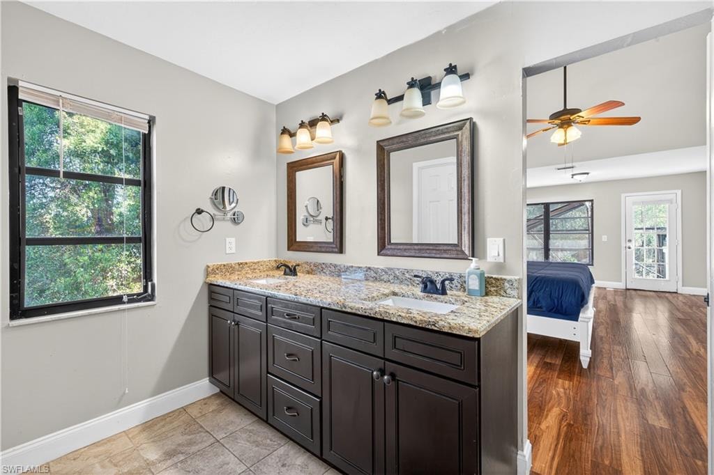 Dual vanity with granite countertop and framed mirrors