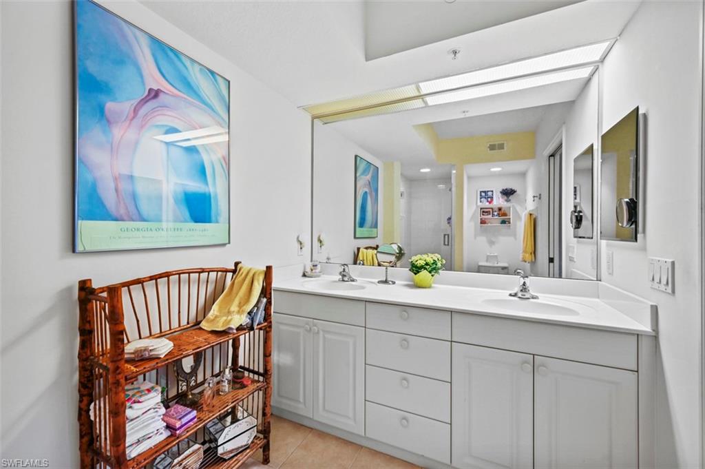 Bathroom with vanity, tile patterned flooring, and an enclosed shower