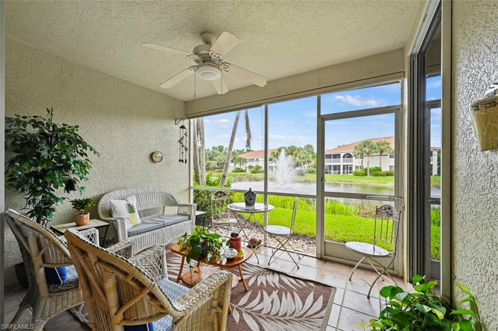 Sunroom / solarium featuring a water view and ceiling fan