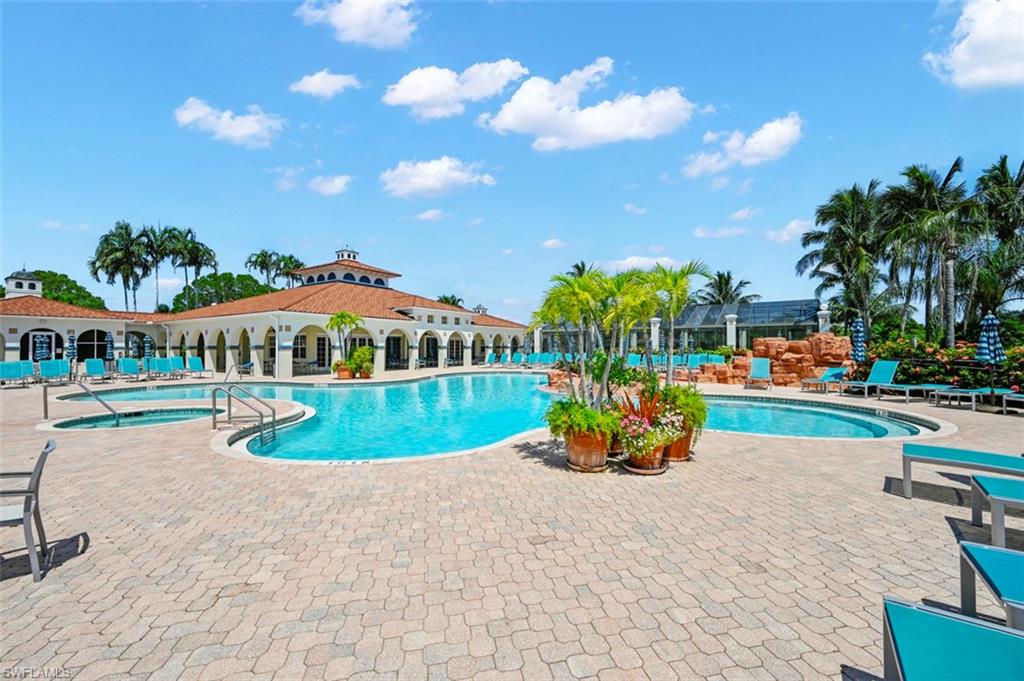 View of pool with a hot tub and a patio area