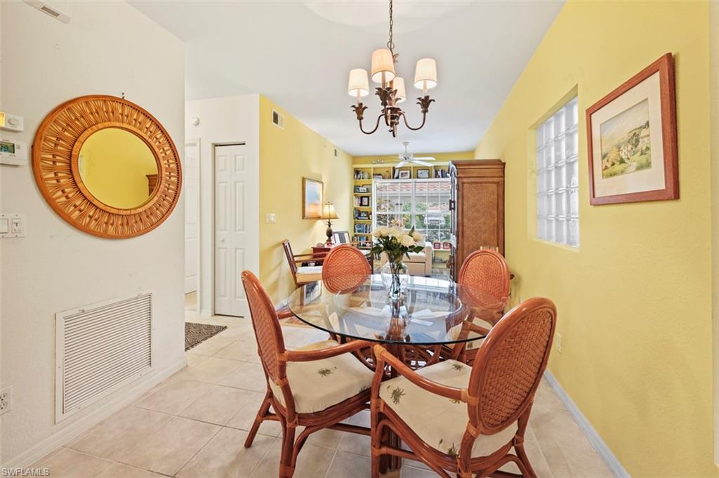 Dining space with an inviting chandelier and light tile patterned flooring