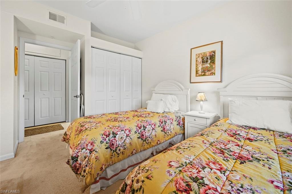 Bedroom featuring ceiling fan, a closet, and light carpet