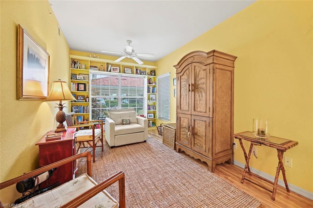 Living area with wood-type flooring and ceiling fan