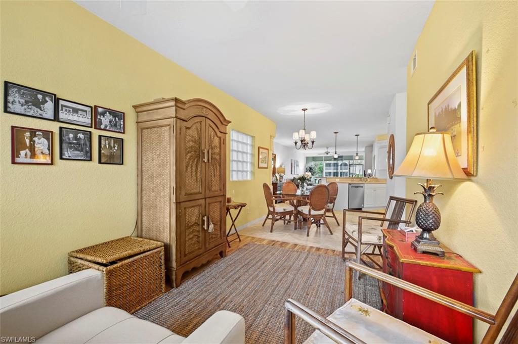 Living room featuring an inviting chandelier and light hardwood / wood-style flooring