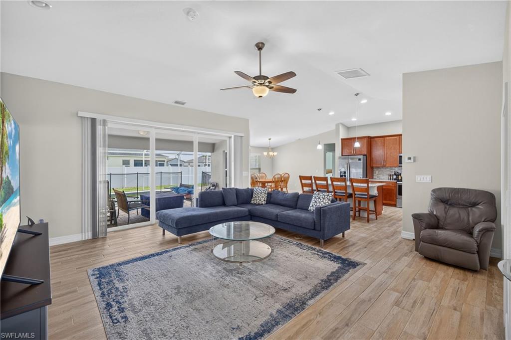 Open concept living area featuring wood-finish flooring and a ceiling fan