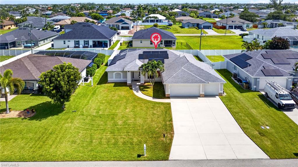 Single-story residence featuring a gray shingle roof and a two-car garage