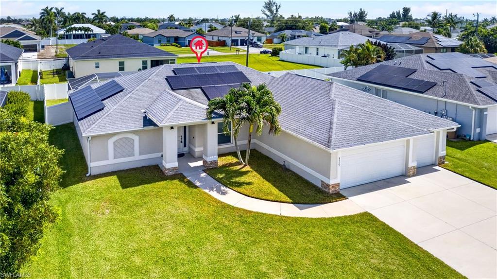 Contemporary single-story residence with a light gray stucco exterior and a gray shingle roof