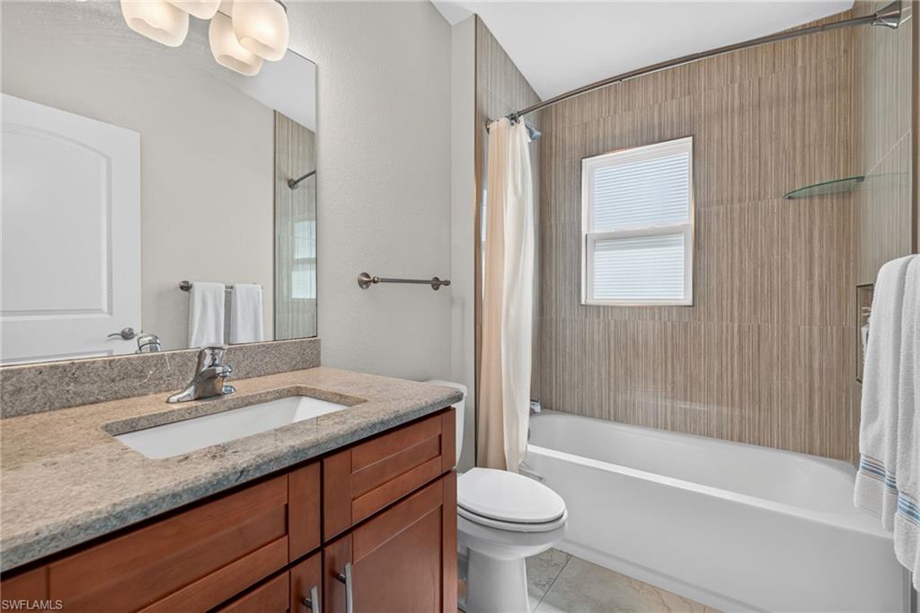 Bathroom featuring a vanity with a light-toned countertop and wood-finish cabinetry