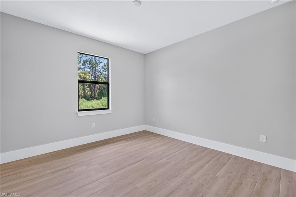 Neutral wall tones with wood-finish flooring