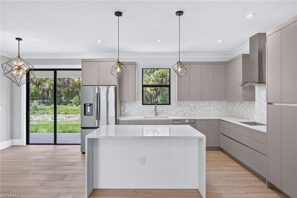 Modern kitchen featuring light wood-finish flooring and a white shiplap island