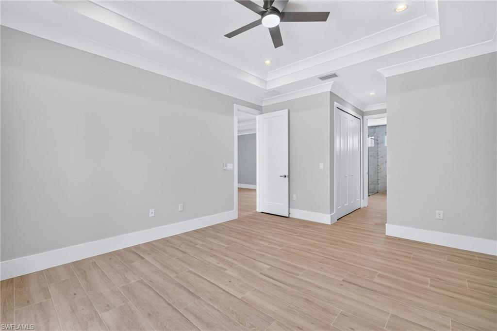 Interior room with neutral gray walls and wood-finish flooring