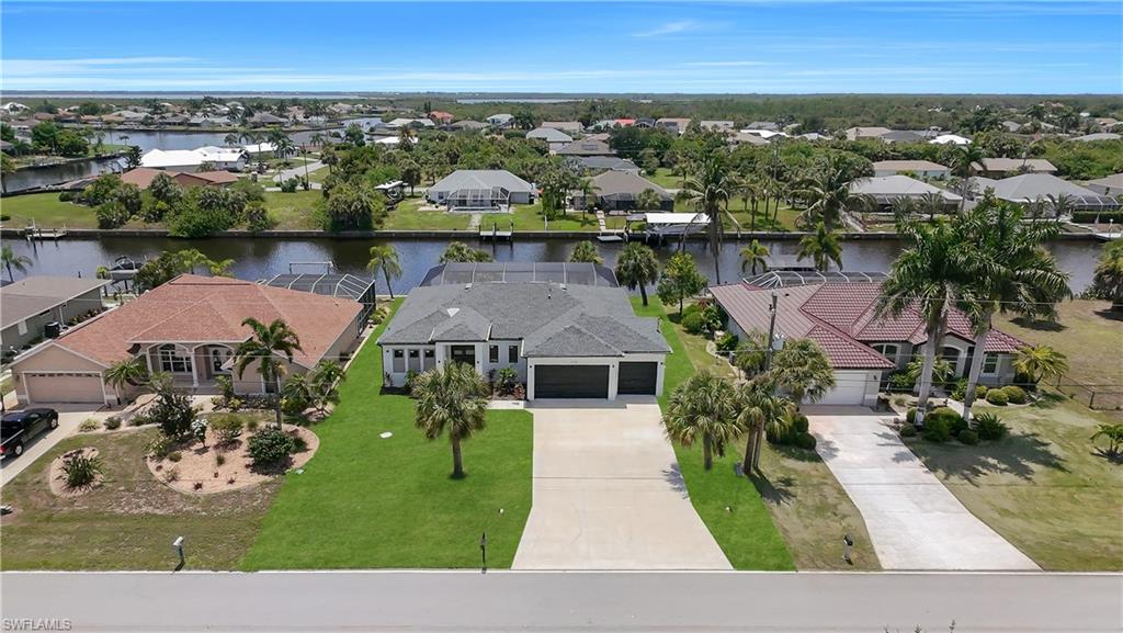 Single-story residence featuring a gray shingle roof, two-car garage, and a concrete driveway