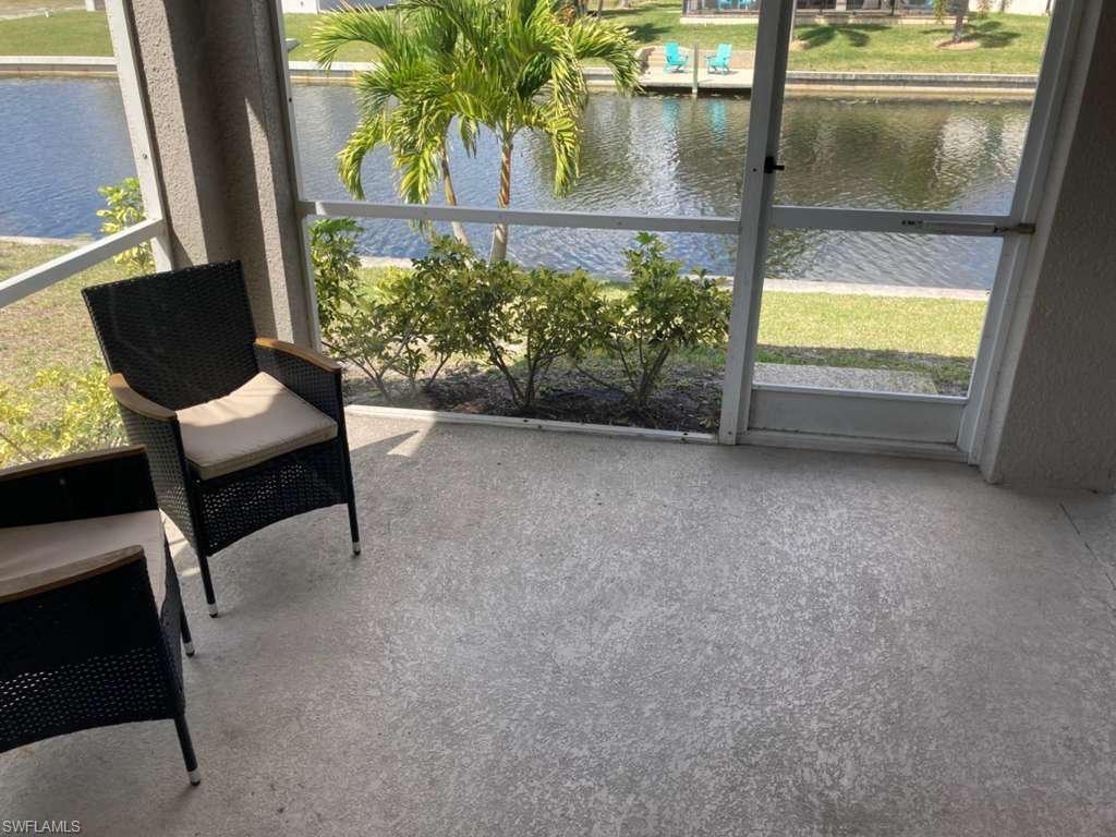 Screened patio featuring a textured concrete floor and water frontage