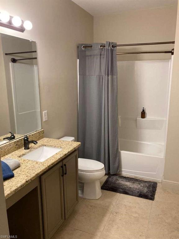 Bathroom with a single vanity featuring a stone-finish countertop and dark bronze hardware