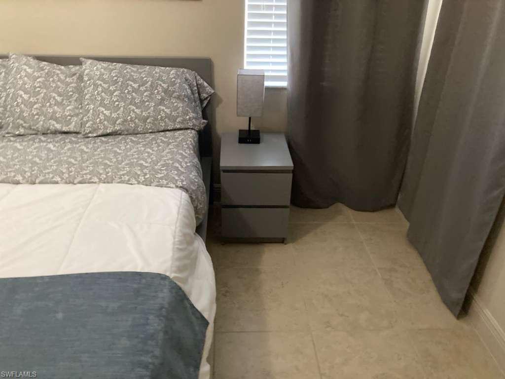 Cream-toned tile flooring complements neutral wall tones
