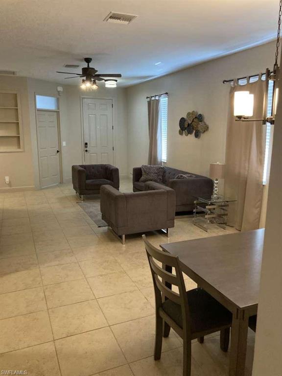 Open concept living space featuring tile flooring and neutral wall tones
