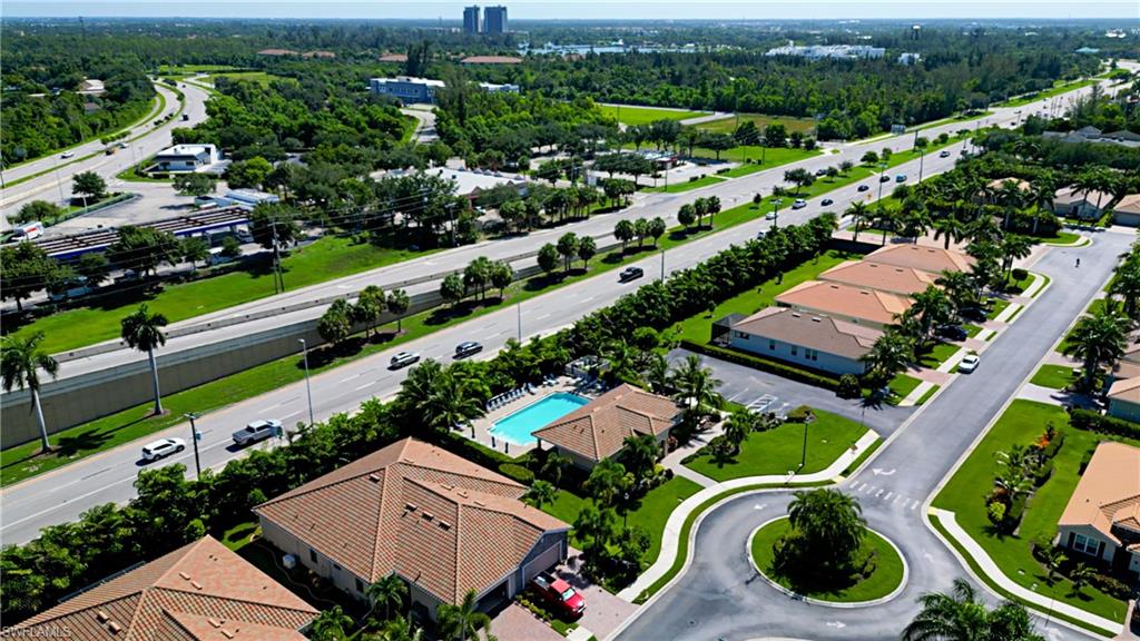 Aerial perspective showcasing a residential community with mature landscaping, a private swimming pool, and a circular street layout