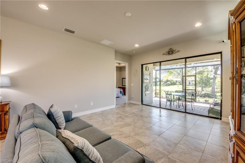 Neutral tone walls with recessed lighting and tile flooring