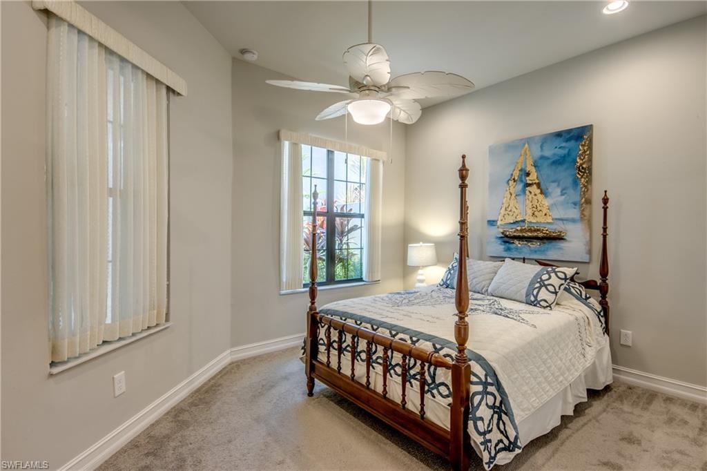 Carpeted room featuring a ceiling fan with integrated lighting, recessed lighting, and crown molding