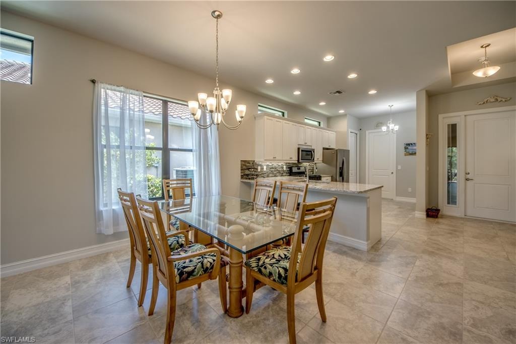 Open concept floorplan featuring a dining area with chandelier lighting and a kitchen with recessed lighting