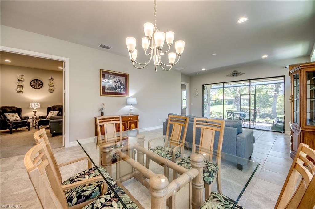 Open-concept living area featuring a ceramic tile floor, recessed lighting, and a multi-light chandelier