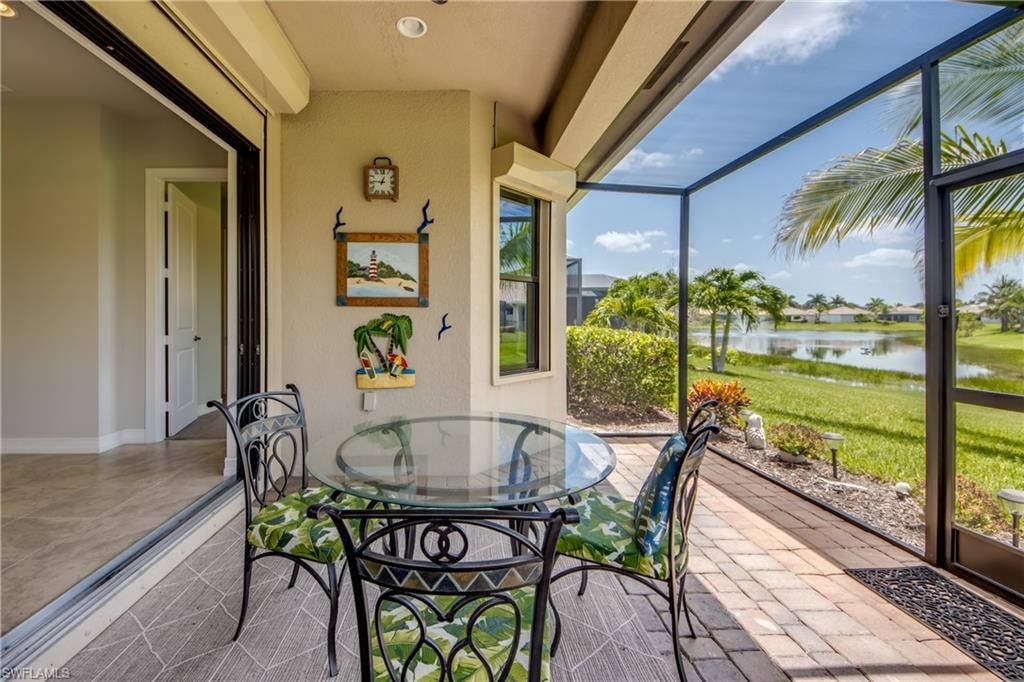Screened lanai featuring a paver flooring, direct water access, and large sliding glass doors
