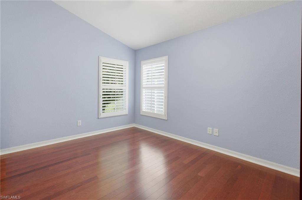Room featuring rich wood-finish flooring and light blue wall tones