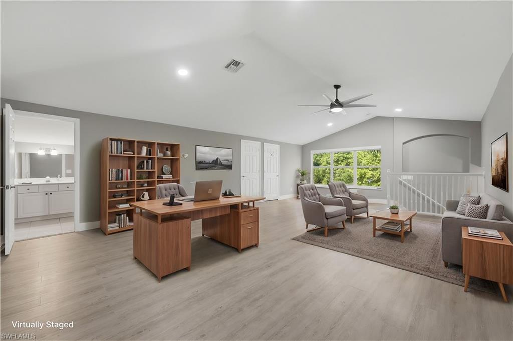 *VIRTUALLY STAGED* Spacious room with vaulted ceilings and light wood-finish flooring