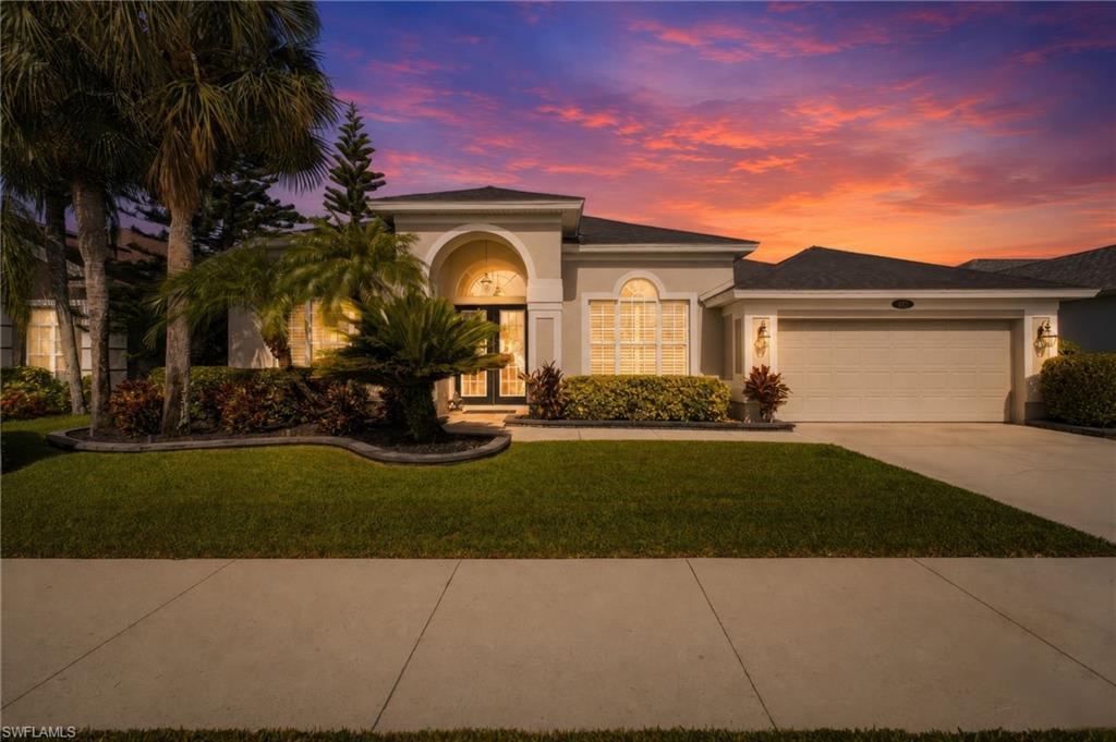 Single-story residence featuring a stucco exterior with an arched entryway