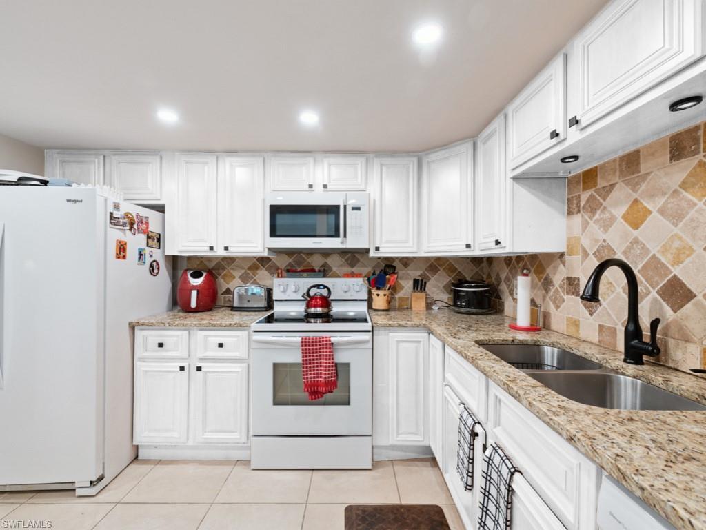 Cabinets were virtually staged white.  Cabinets were replaced with new white cabinets