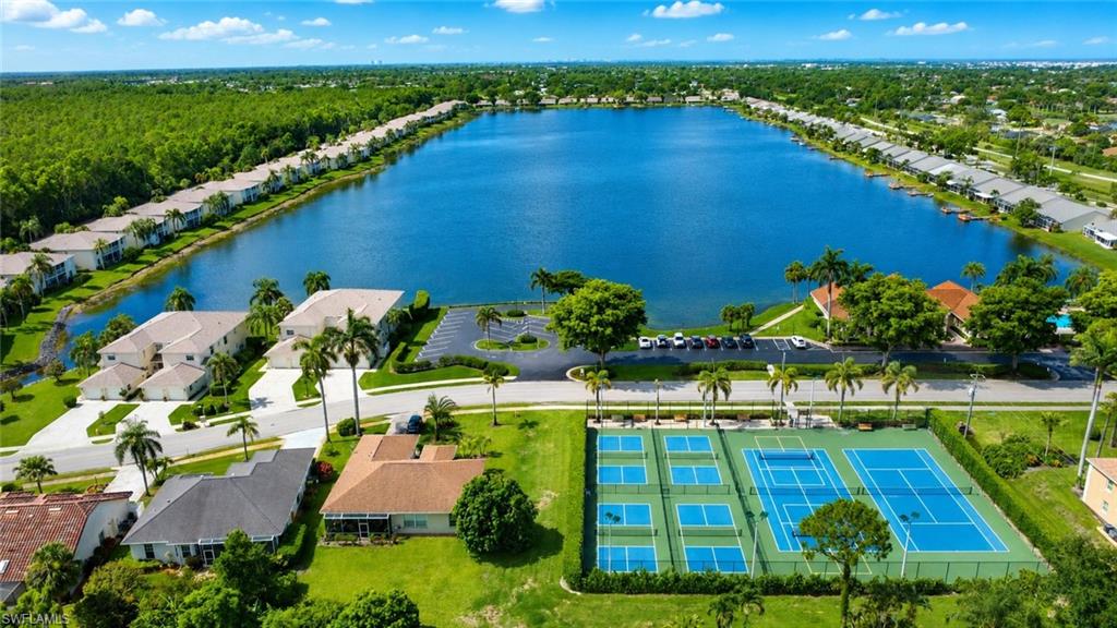 Expansive lakefront community featuring multiple tennis courts, pickleball courts, and a large central lake