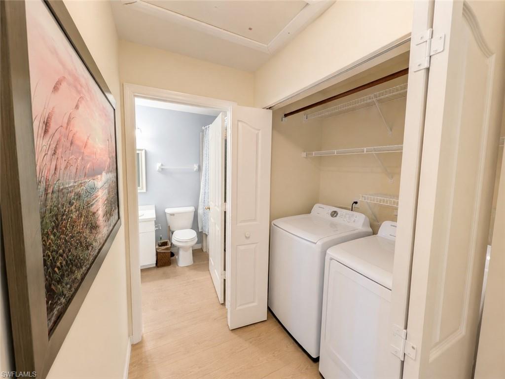 Hallway laundry closet with wire shelving