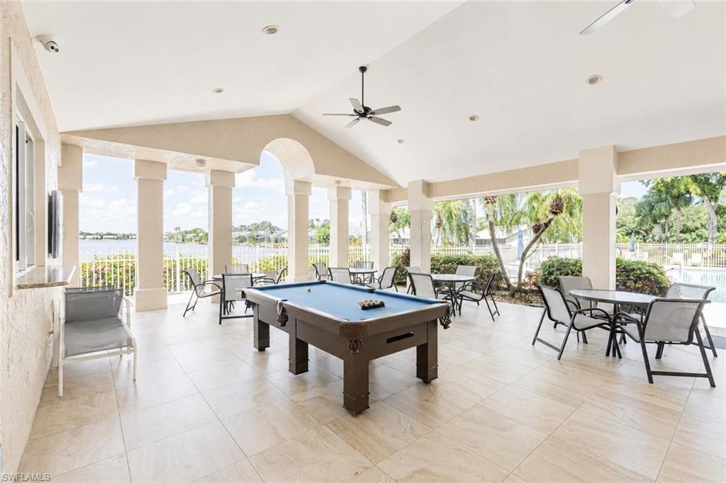 Covered outdoor patio featuring a vaulted ceiling and tile flooring