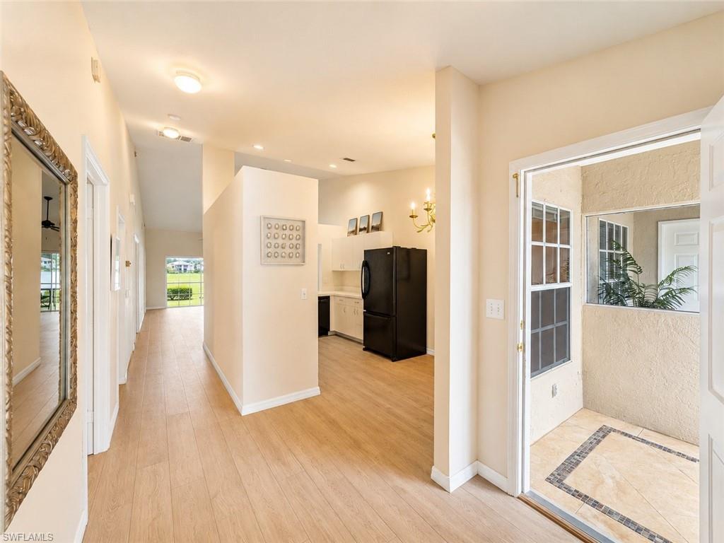 Spacious entryway featuring light wood-finish flooring, recessed lighting, and an open concept layout