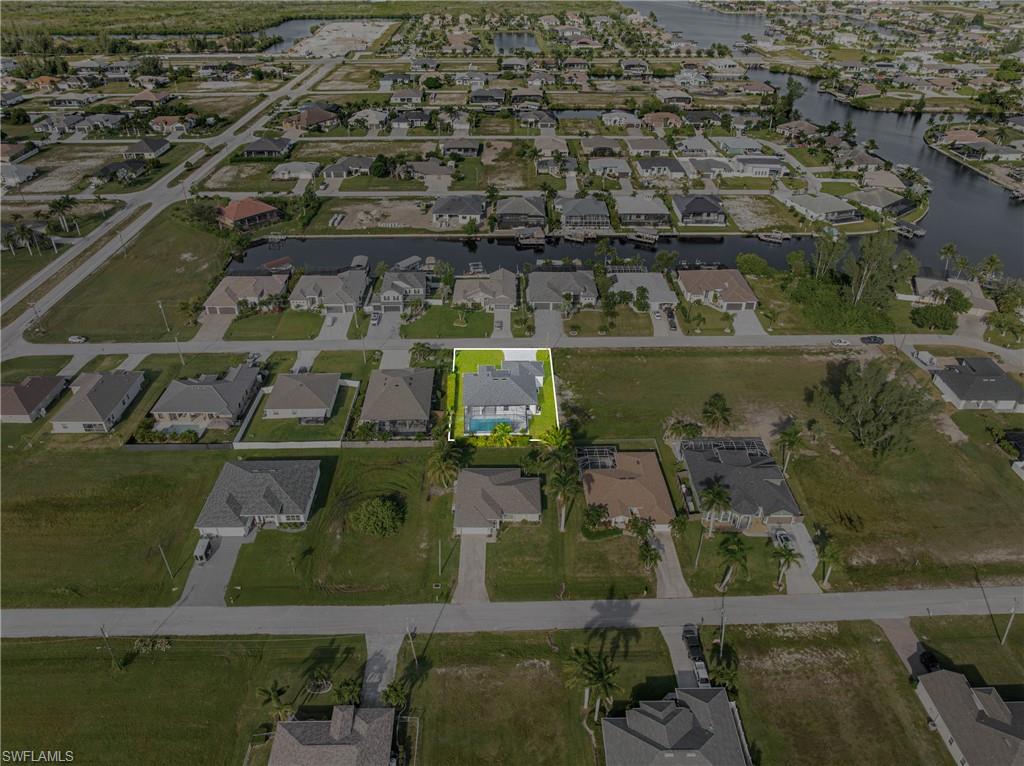 Aerial view of property's location featuring nearby suburban area and a nearby body of water