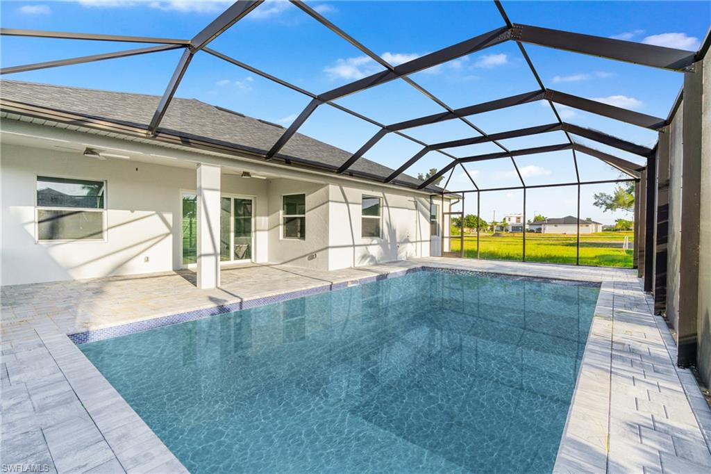 Outdoor pool with a sunroom, a lanai, and a patio area