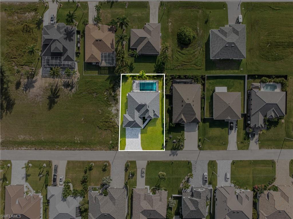 Aerial view of residential area with property boundaries highlighted