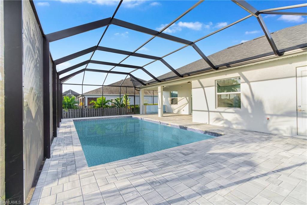 Swimming pool featuring a sunroom, a patio area, and a lanai