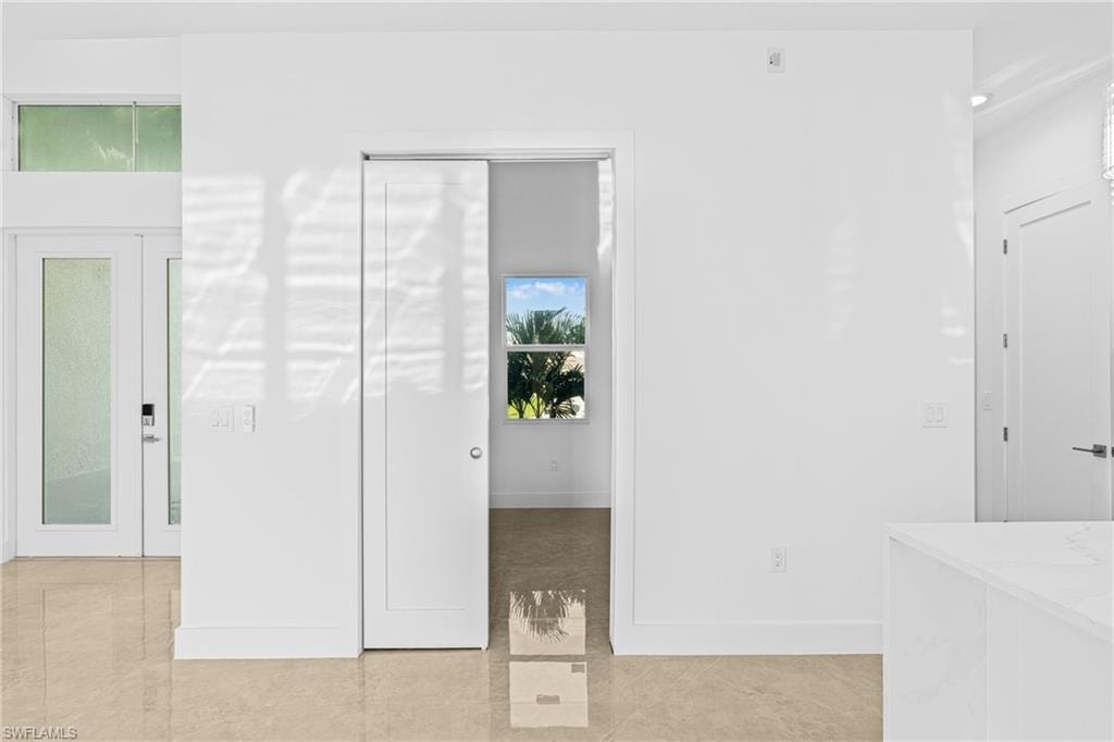 Unfurnished bedroom featuring baseboards and light tile patterned floors