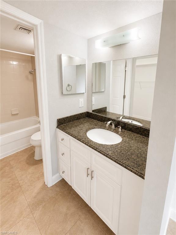 Vanity with a granite-style countertop and an integrated oval sink