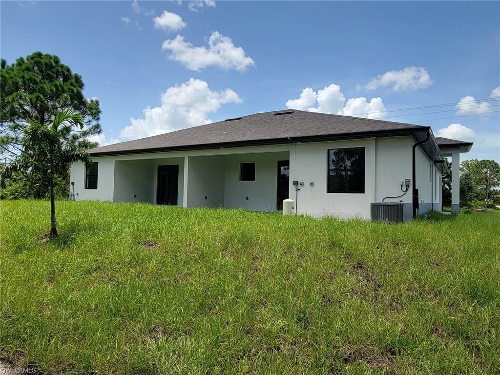 Back of property featuring cooling unit