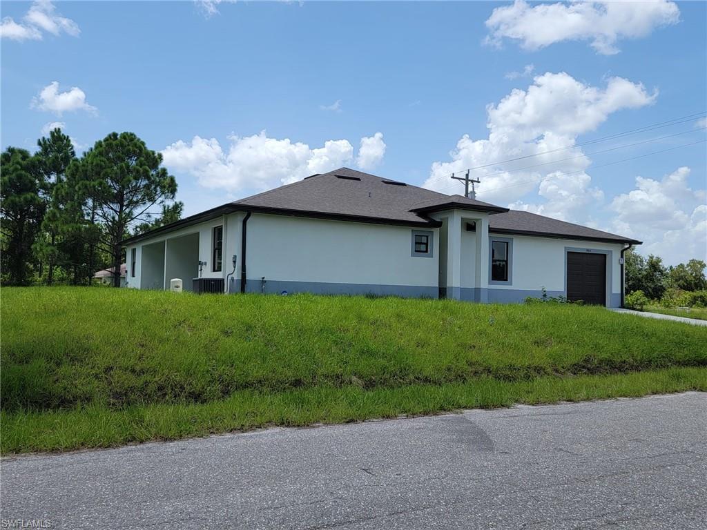 View of side of property with a garage