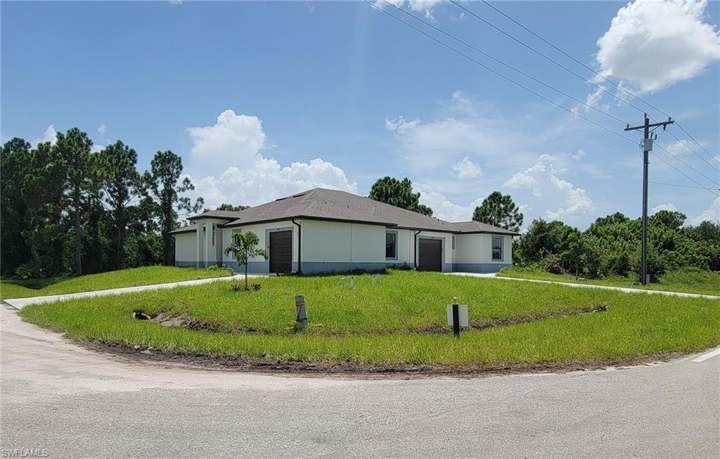 View of front of home featuring a garage and a front yard