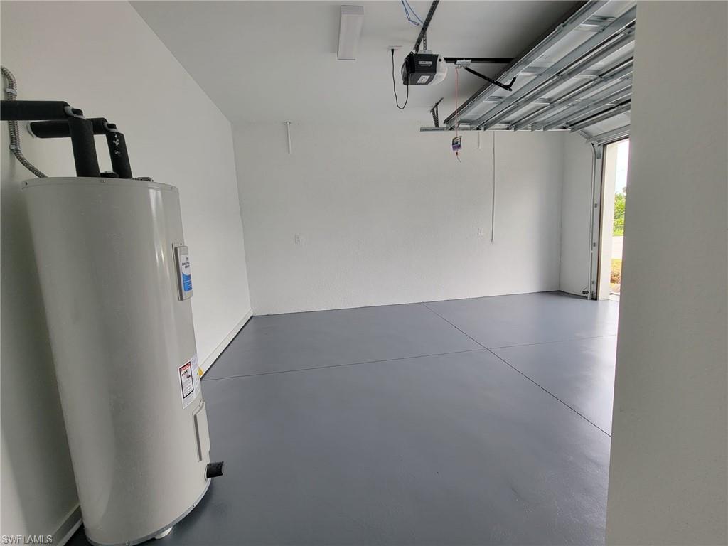 Garage with water heater and a garage door opener