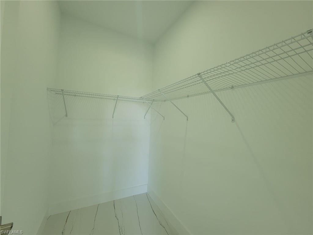Walk in closet with tile patterned floors