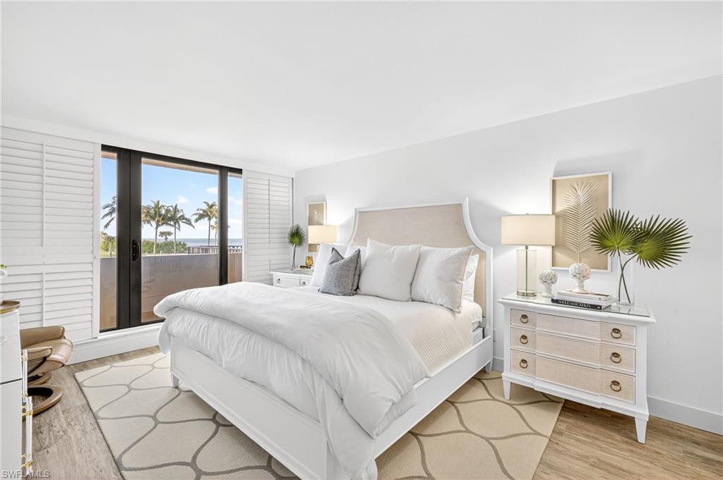 Bedroom with light wood-type flooring and access to the lanai