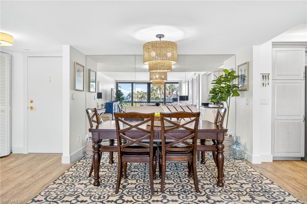 Dining area with light wood-style floors and baseboards