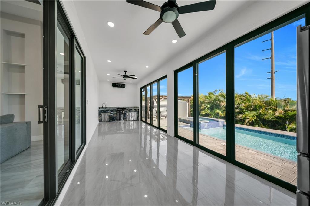 Polished tile flooring, recessed lighting, and built-in shelving