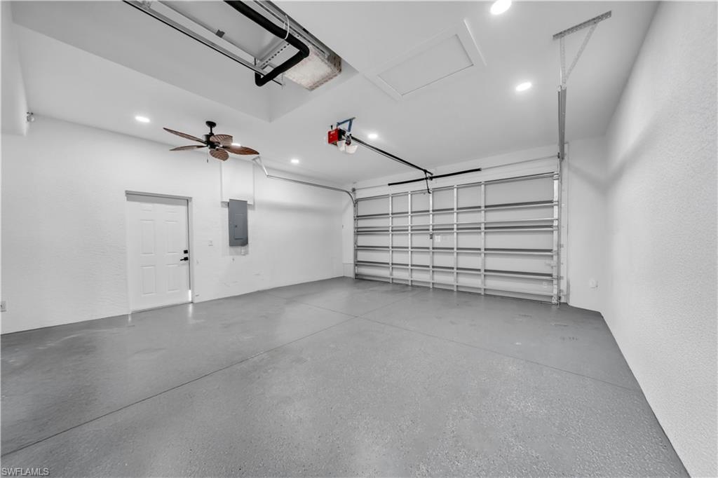 Spacious garage featuring a finished floor, recessed lighting, and a ceiling fan
