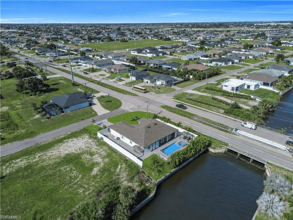 Waterfront property featuring a private pool, concrete patio, and direct canal access
